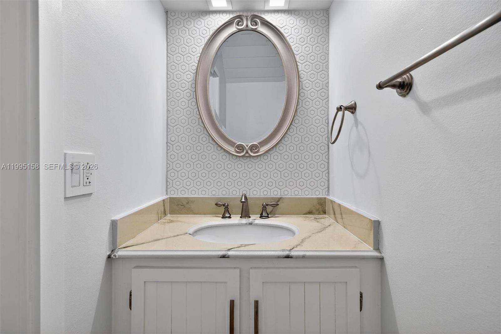 6161 Southwest 90th Court, Unit G2 Miami, FL 33173 - Photo 19 of 47 a bathroom with a granite countertop sink and a mirror
