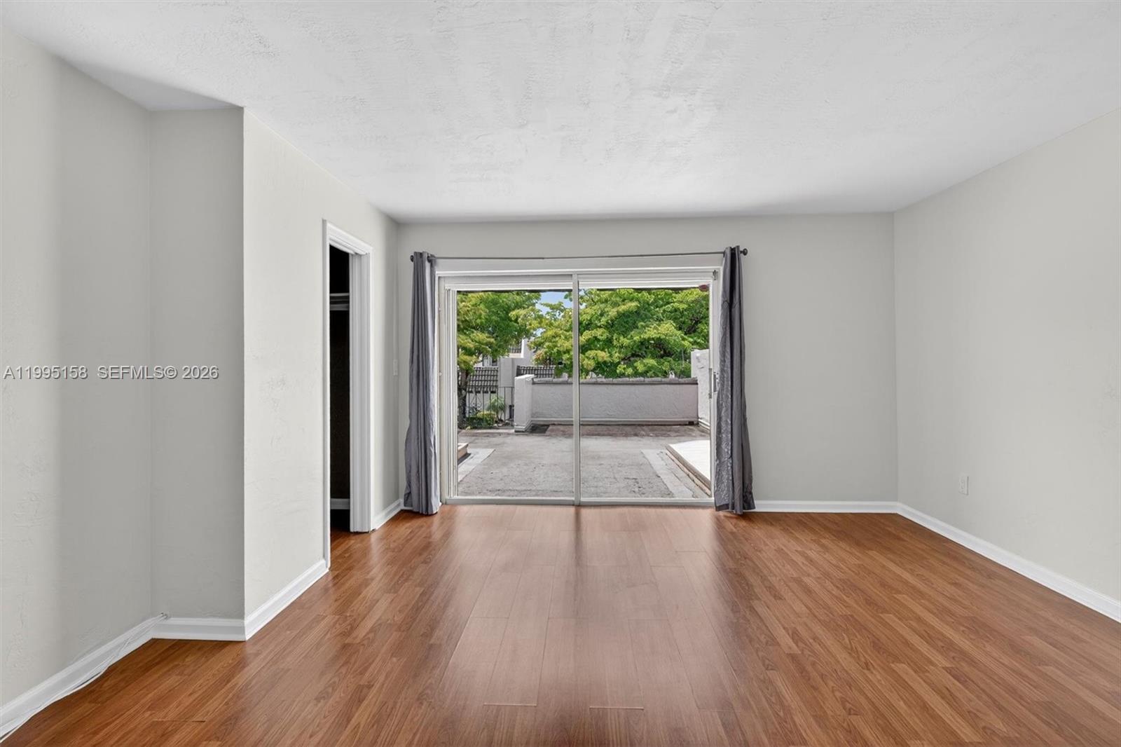 6161 Southwest 90th Court, Unit G2 Miami, FL 33173 - Photo 27 of 47 a view of a room with wooden floor and natural light