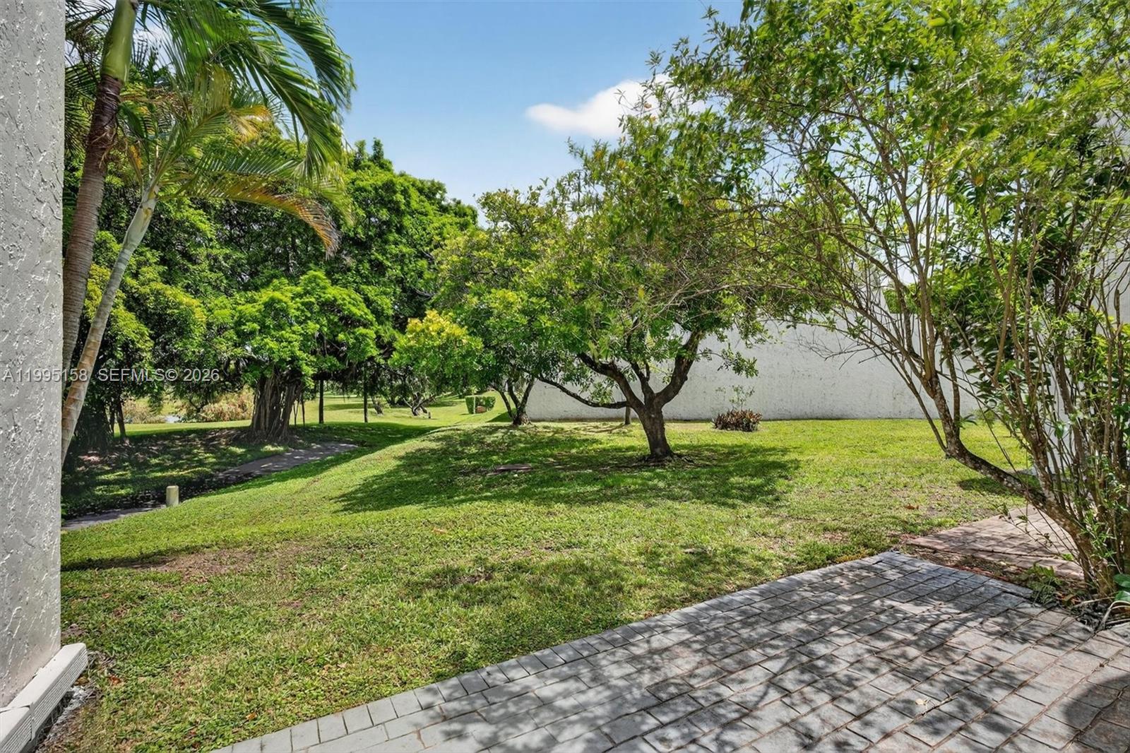 6161 Southwest 90th Court, Unit G2 Miami, FL 33173 - Photo 33 of 47 a view of a backyard with large trees