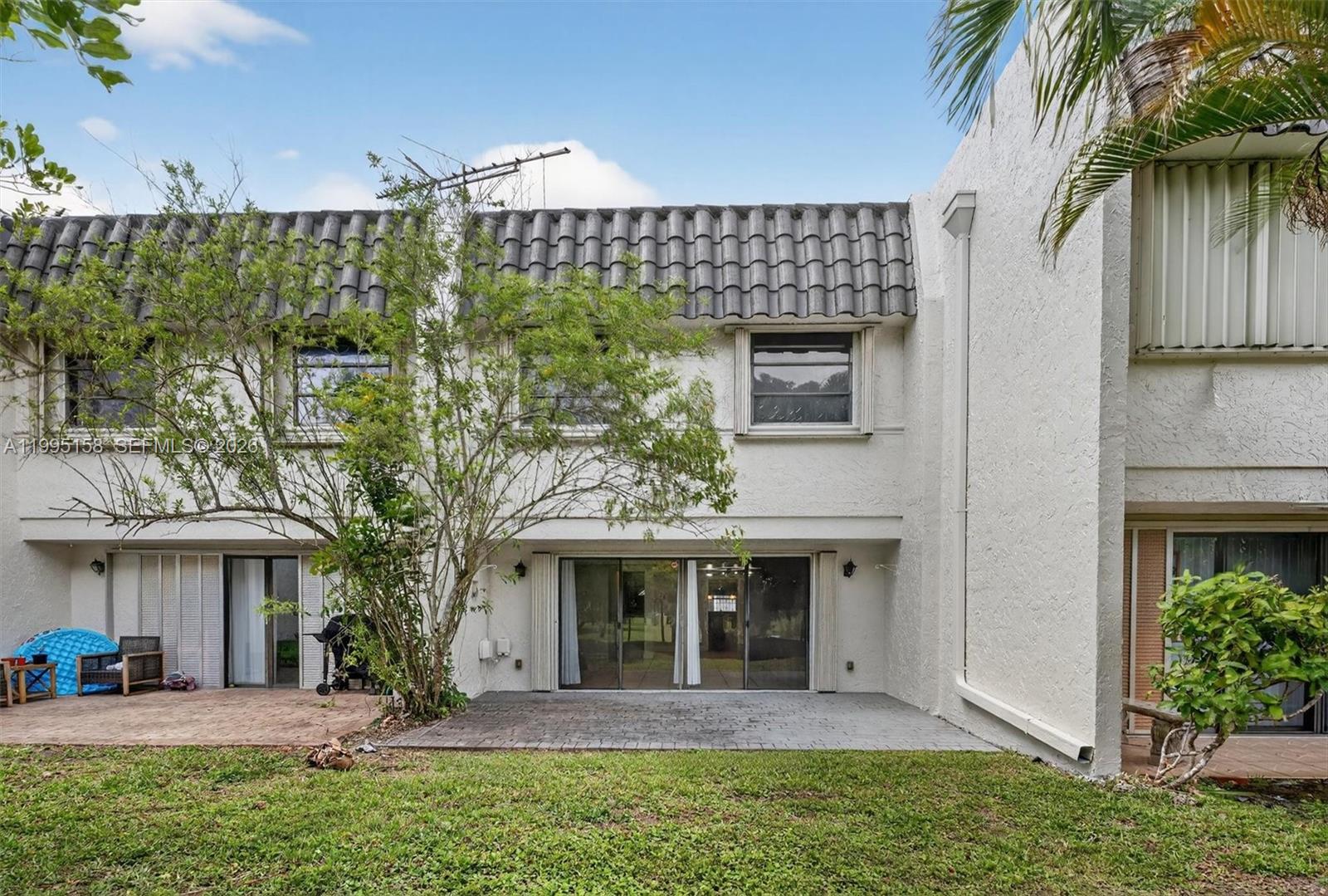6161 Southwest 90th Court, Unit G2 Miami, FL 33173 - Photo 34 of 47 a front view of a house with a yard