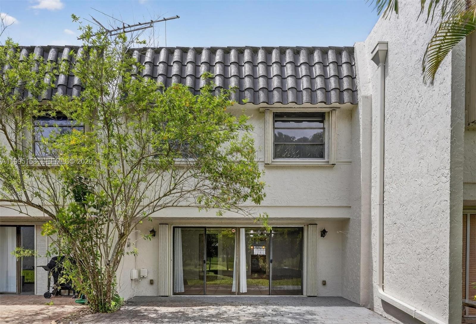 6161 Southwest 90th Court, Unit G2 Miami, FL 33173 - Photo 35 of 47 a front view of a house with a garden