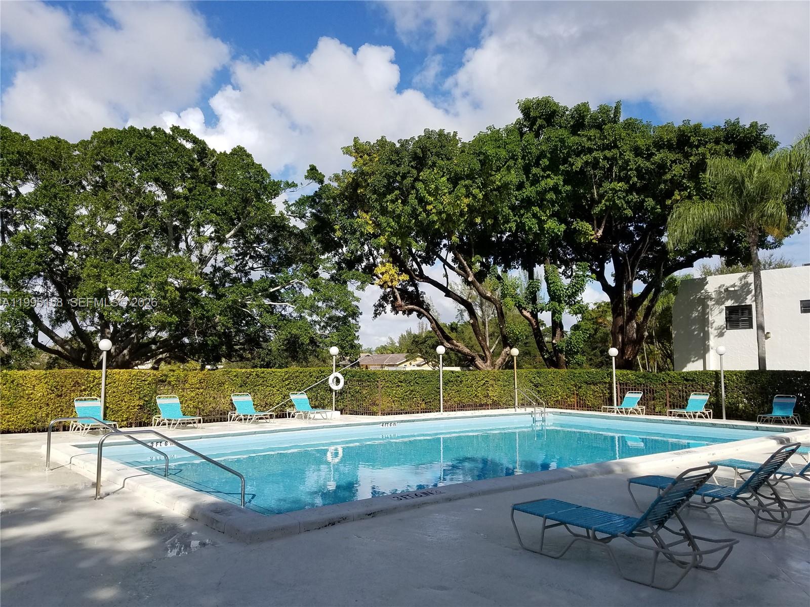 6161 Southwest 90th Court, Unit G2 Miami, FL 33173 - Photo 41 of 47 a view of backyard with swimming pool and green space