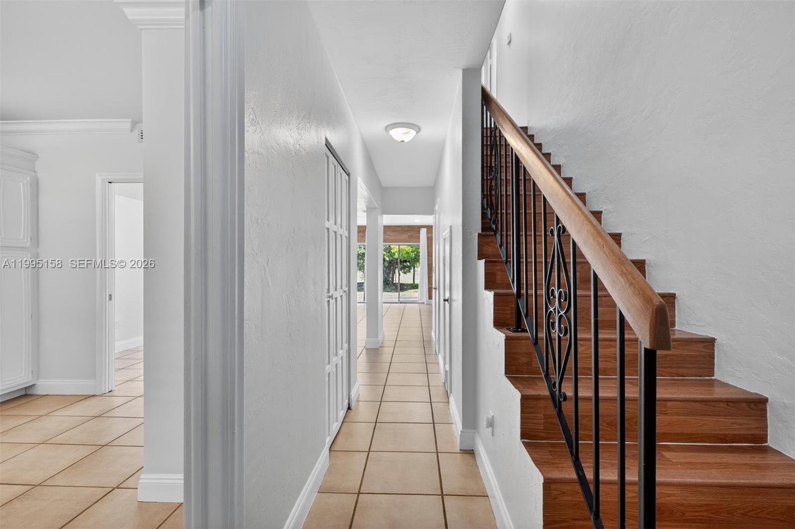 6161 Southwest 90th Court, Unit G2 Miami, FL 33173 - Photo 6 of 47 a view of a hallway with wooden floor and staircase