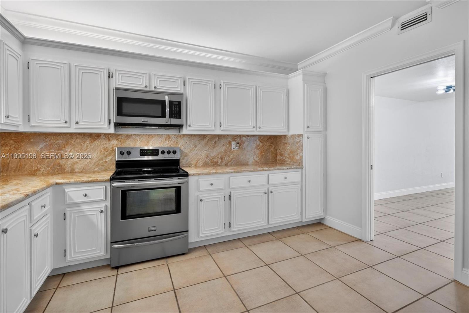 6161 Southwest 90th Court, Unit G2 Miami, FL 33173 - Photo 7 of 47 a kitchen with white cabinets stainless steel appliances and sink