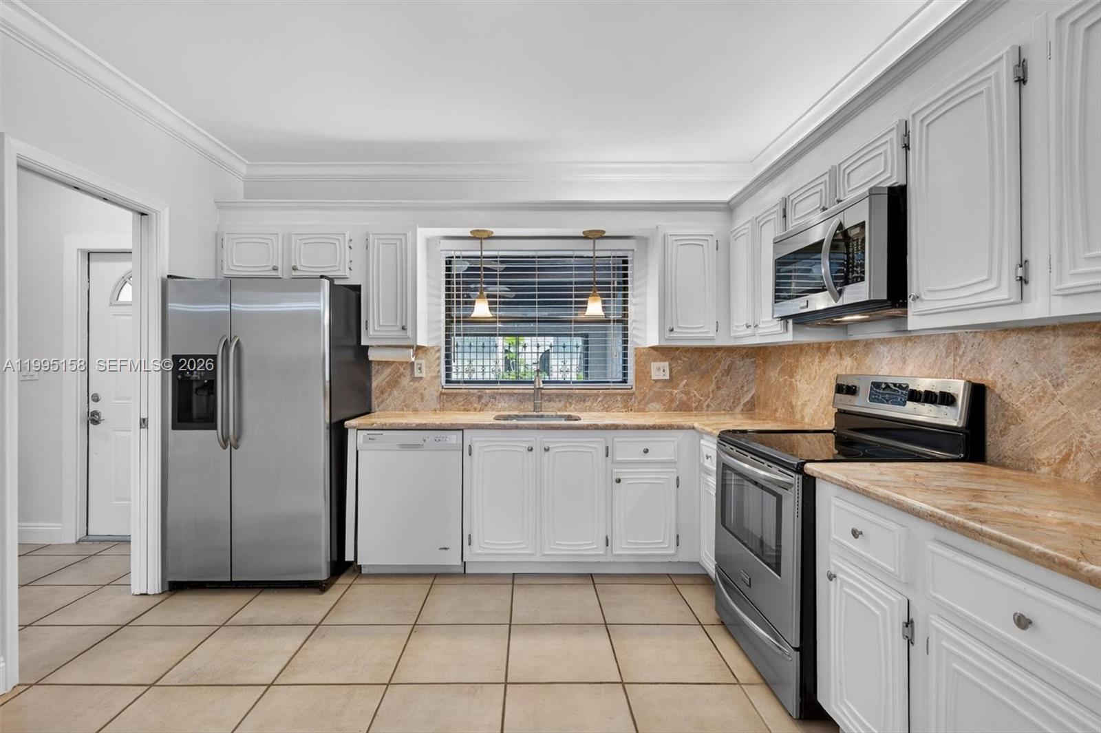 6161 Southwest 90th Court, Unit G2 Miami, FL 33173 - Photo 10 of 47 a kitchen with a stove a sink and a refrigerator