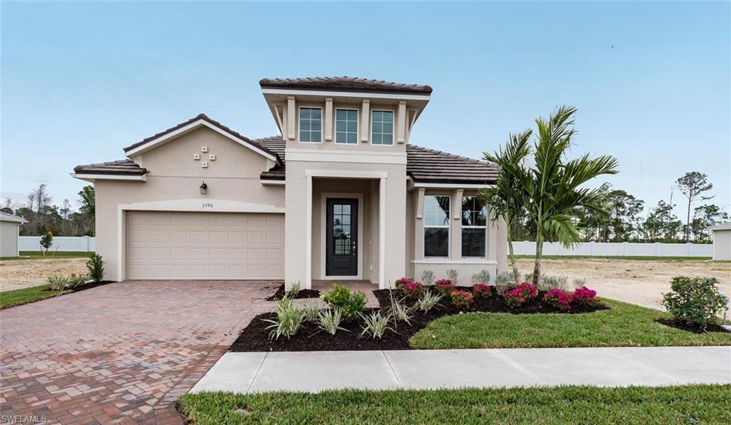 3509 Pilot Circle Naples, FL 34120 - Photo 1 of 32 a front view of a house with a yard and potted plants