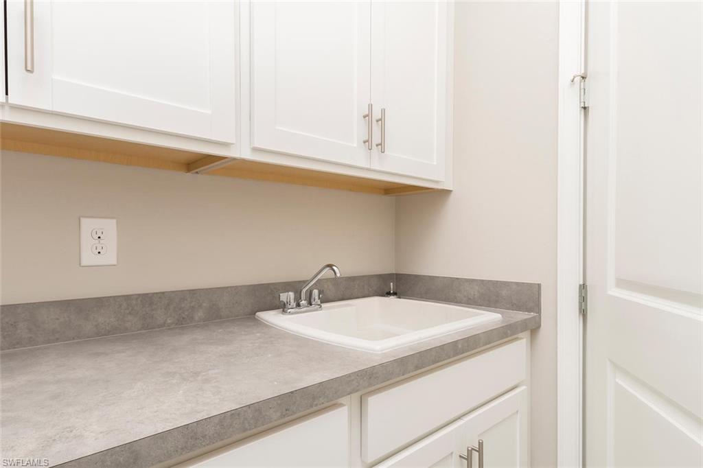 3509 Pilot Circle Naples, FL 34120 - Photo 26 of 32 a bathroom with a sink and a mirror