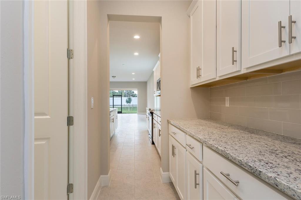 3509 Pilot Circle Naples, FL 34120 - Photo 8 of 32 a view of a kitchen with granite countertop cabinets