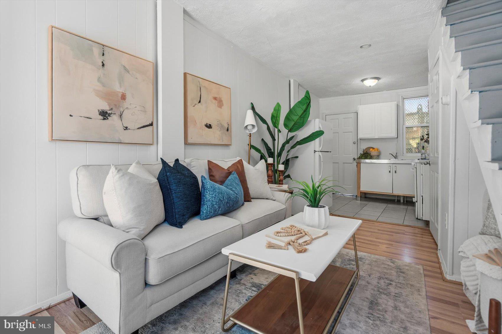 a living room with furniture and wooden floor
