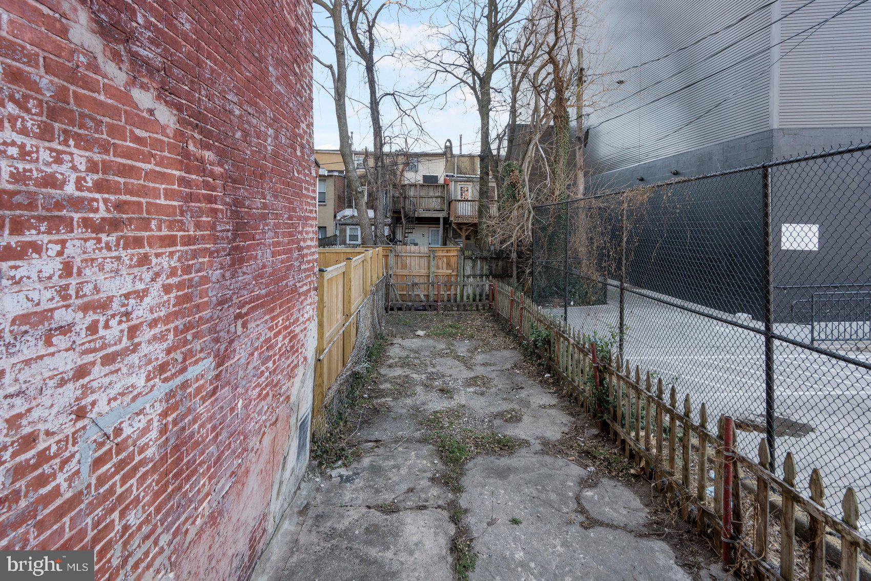1017 Sterrett Street Baltimore, MD 21230 - Photo 26 of 29 a view of a pathway with a wrought fence