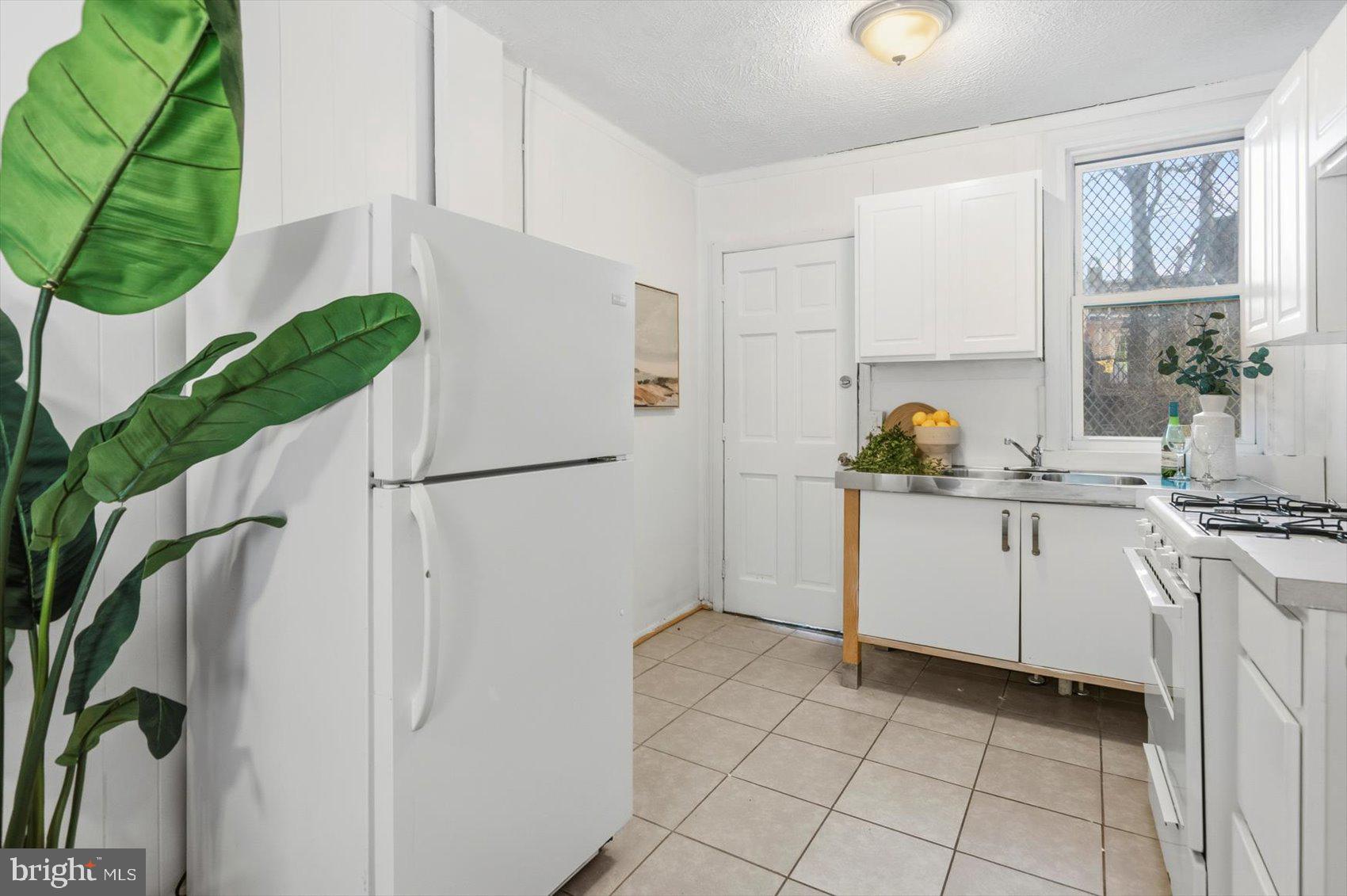 1017 Sterrett Street Baltimore, MD 21230 - Photo 9 of 29 a kitchen with a white cabinets and window