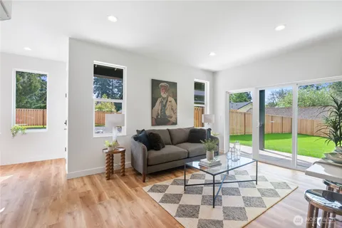 a living room with furniture and a wooden floor