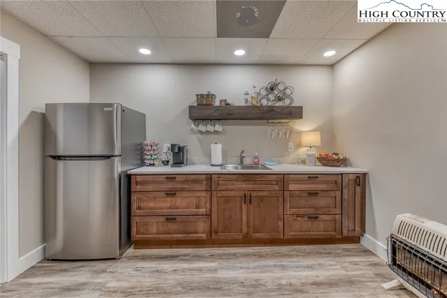 a kitchen with stainless steel appliances granite countertop a refrigerator and a cabinets