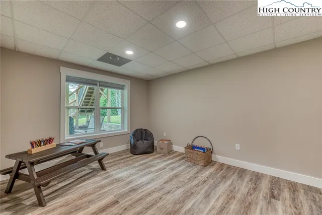 a view of a room with a window and a wooden floor