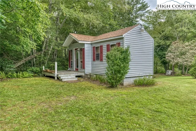 a view of house with backyard