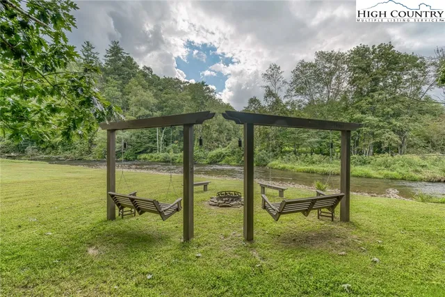a swimming pool with outdoor seating and yard