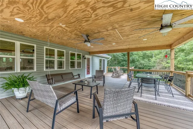 a view of a patio with dining table and chairs