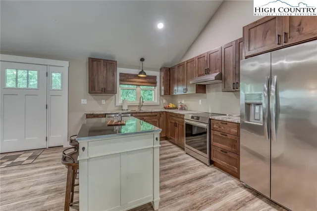 a kitchen with a stove a sink and a refrigerator