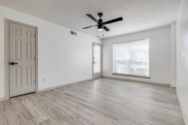 wooden floor in an empty room with a window