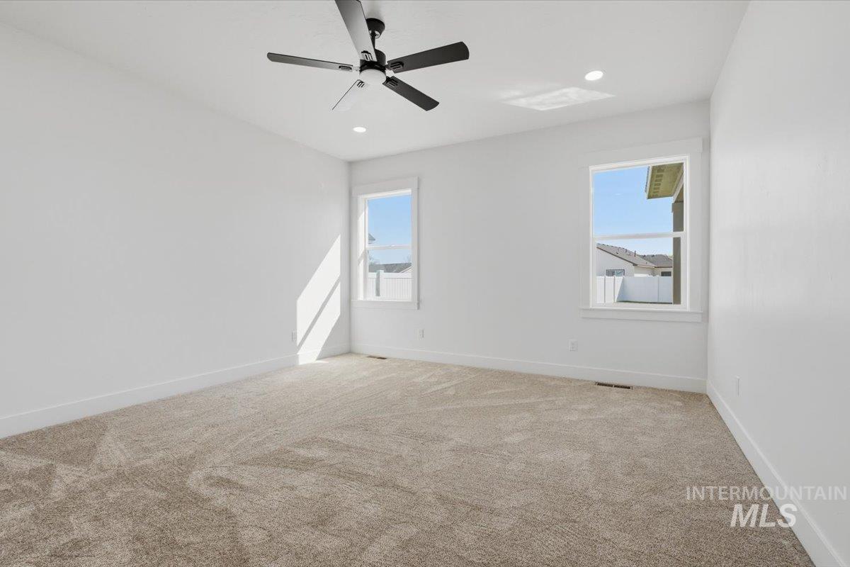 2175 Austin Way Fruitland, ID 83619 - Photo 21 of 30 Carpeted spare room featuring a ceiling fan and recessed lighting