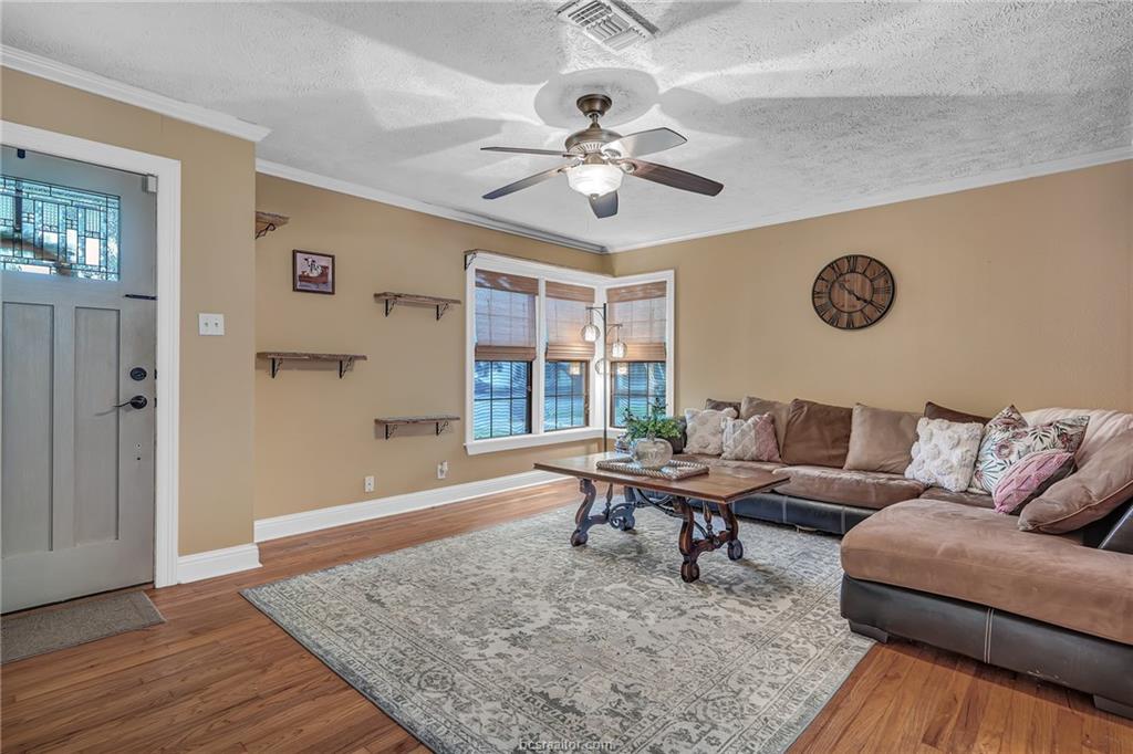 1414 East 29th Street Bryan, TX 77802 - Photo 3 of 21 a living room with couches and a table with wooden floor