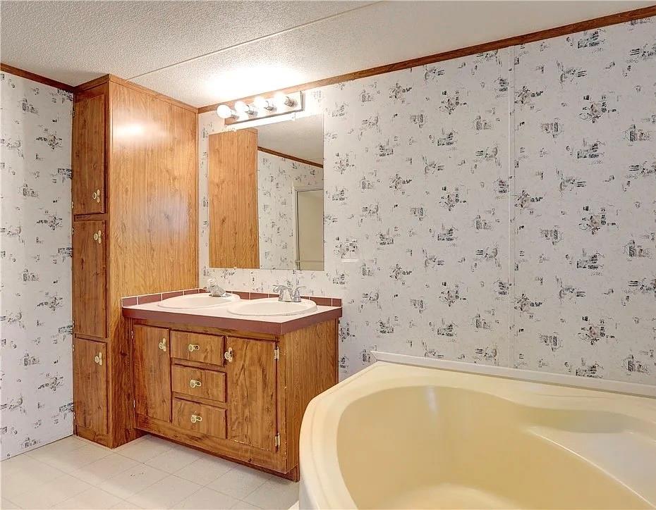3697 Fm 2808 Road Kempner, TX 76539 - Photo 16 of 18 a bathroom with a granite countertop sink and a bathtub