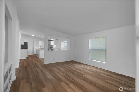a view of wooden floor and windows in a room