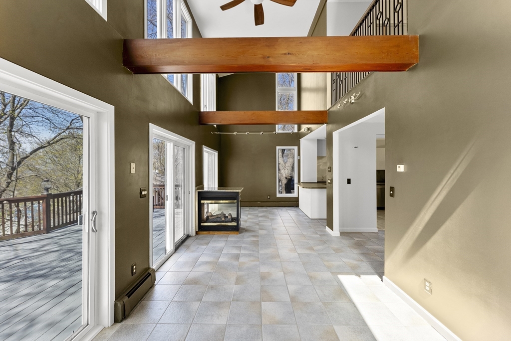 43 Farina Road Hull, MA 02045 - Photo 12 of 39 a view of a hallway with wooden shelves and a refrigerator