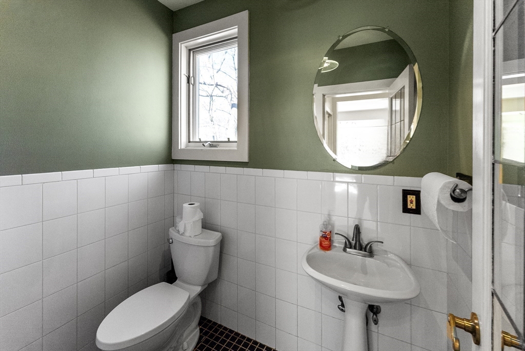 43 Farina Road Hull, MA 02045 - Photo 17 of 39 a bathroom with a toilet sink and mirror