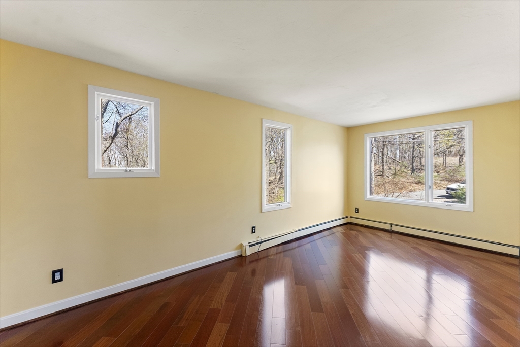 43 Farina Road Hull, MA 02045 - Photo 22 of 39 a view of an empty room with window and wooden floor