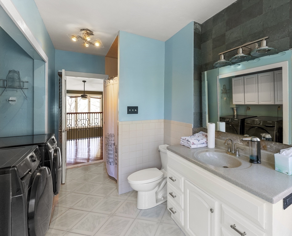 43 Farina Road Hull, MA 02045 - Photo 24 of 39 a bathroom with a sink a toilet and a mirror