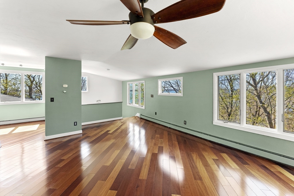 43 Farina Road Hull, MA 02045 - Photo 26 of 39 a view of empty room with wooden floor and fan