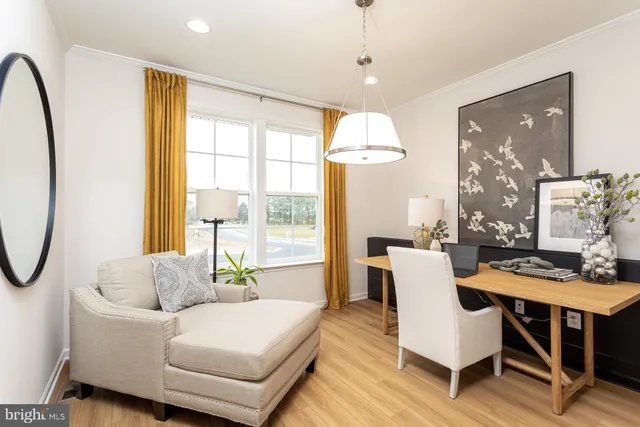 a living room with furniture a table and a large window