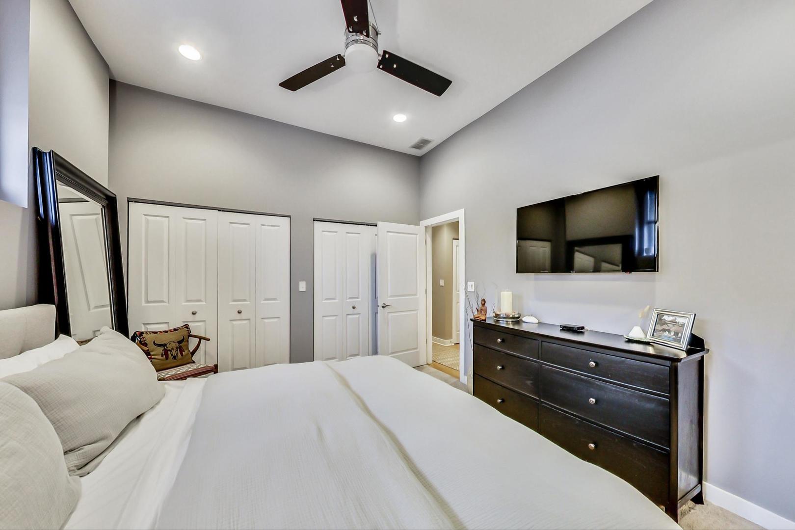 1256 North Cleaver Street, Unit 2E Chicago, IL 60642 - Photo 12 of 18 a bedroom with a bed and a flat screen tv