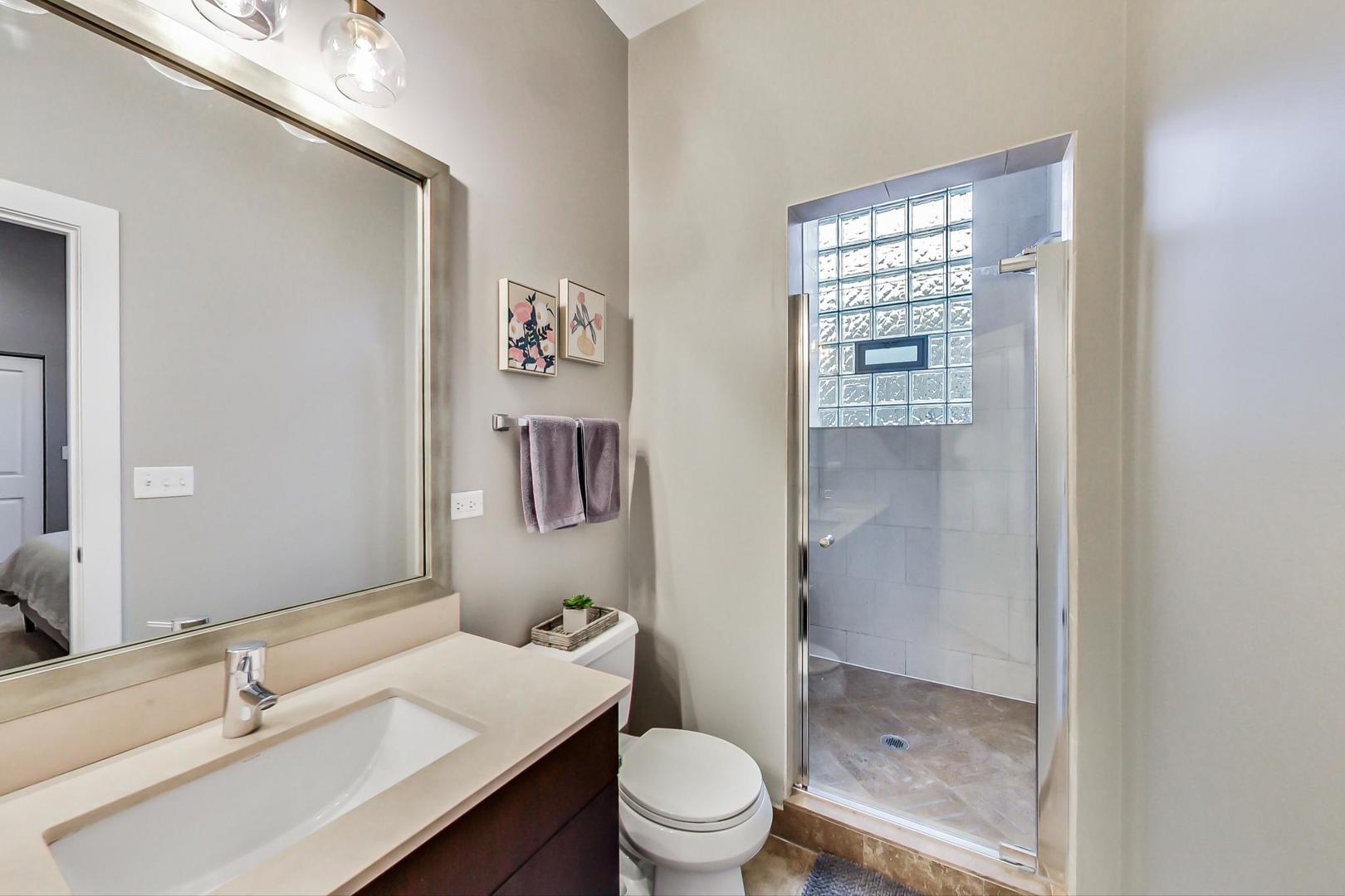 1256 North Cleaver Street, Unit 2E Chicago, IL 60642 - Photo 14 of 18 a bathroom with a sink toilet and shower