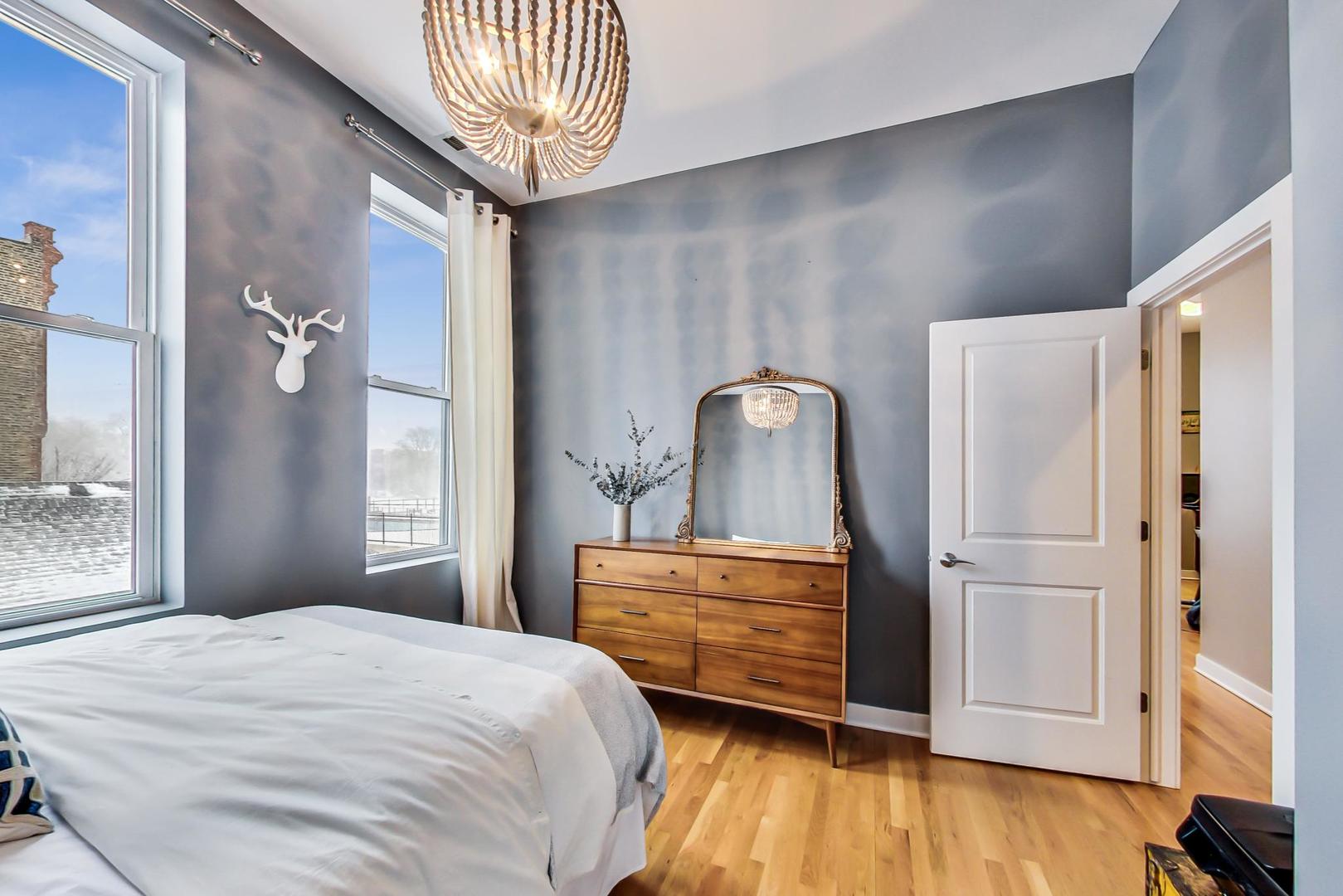 1256 North Cleaver Street, Unit 2E Chicago, IL 60642 - Photo 16 of 18 a bedroom with a bed and a dresser