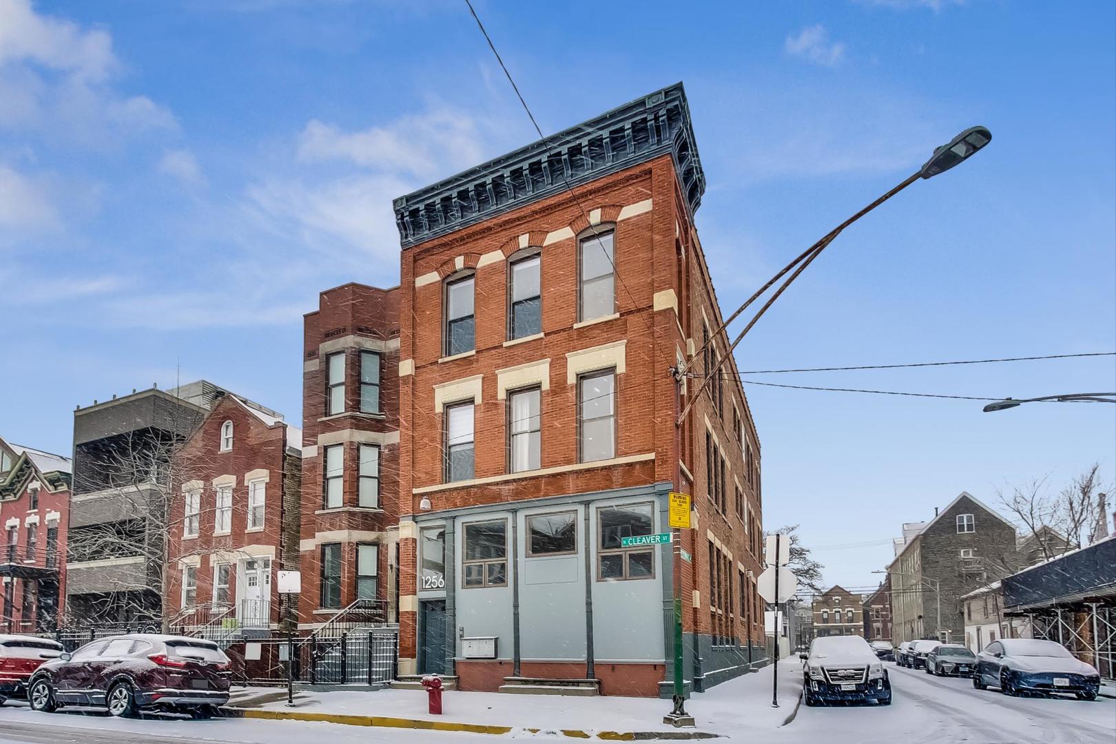 1256 North Cleaver Street, Unit 2E Chicago, IL 60642 - Photo 2 of 18 a city street lined with buildings and cars