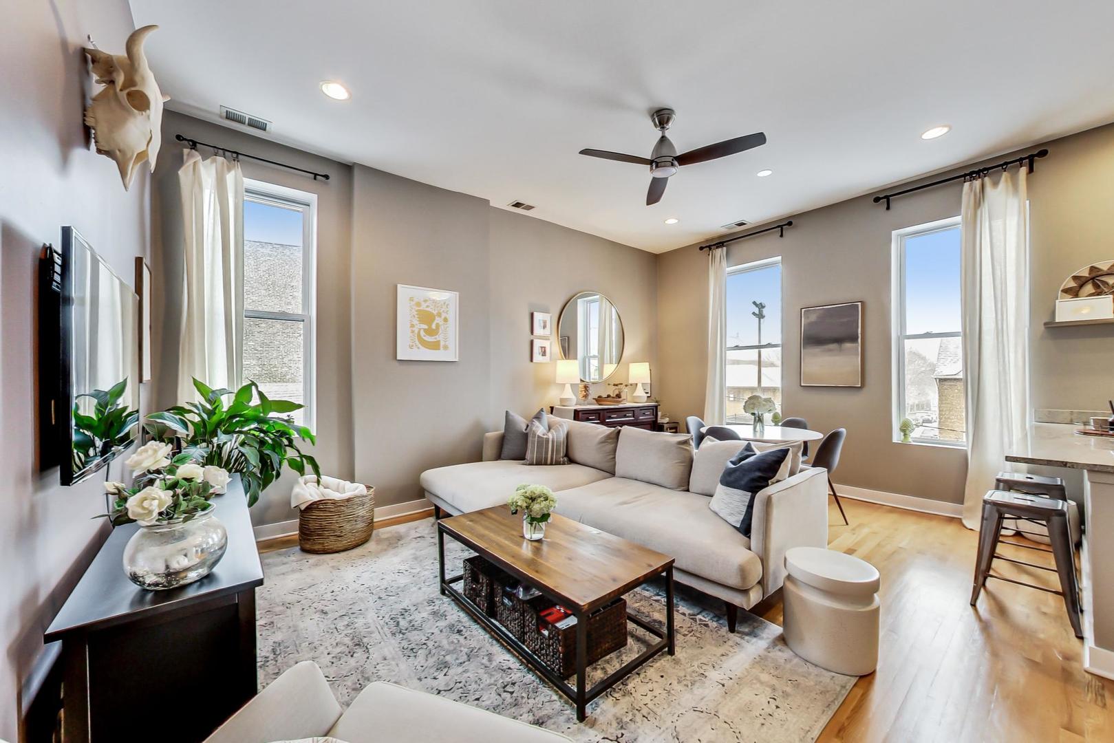 1256 North Cleaver Street, Unit 2E Chicago, IL 60642 - Photo 3 of 18 a living room with furniture and a large window