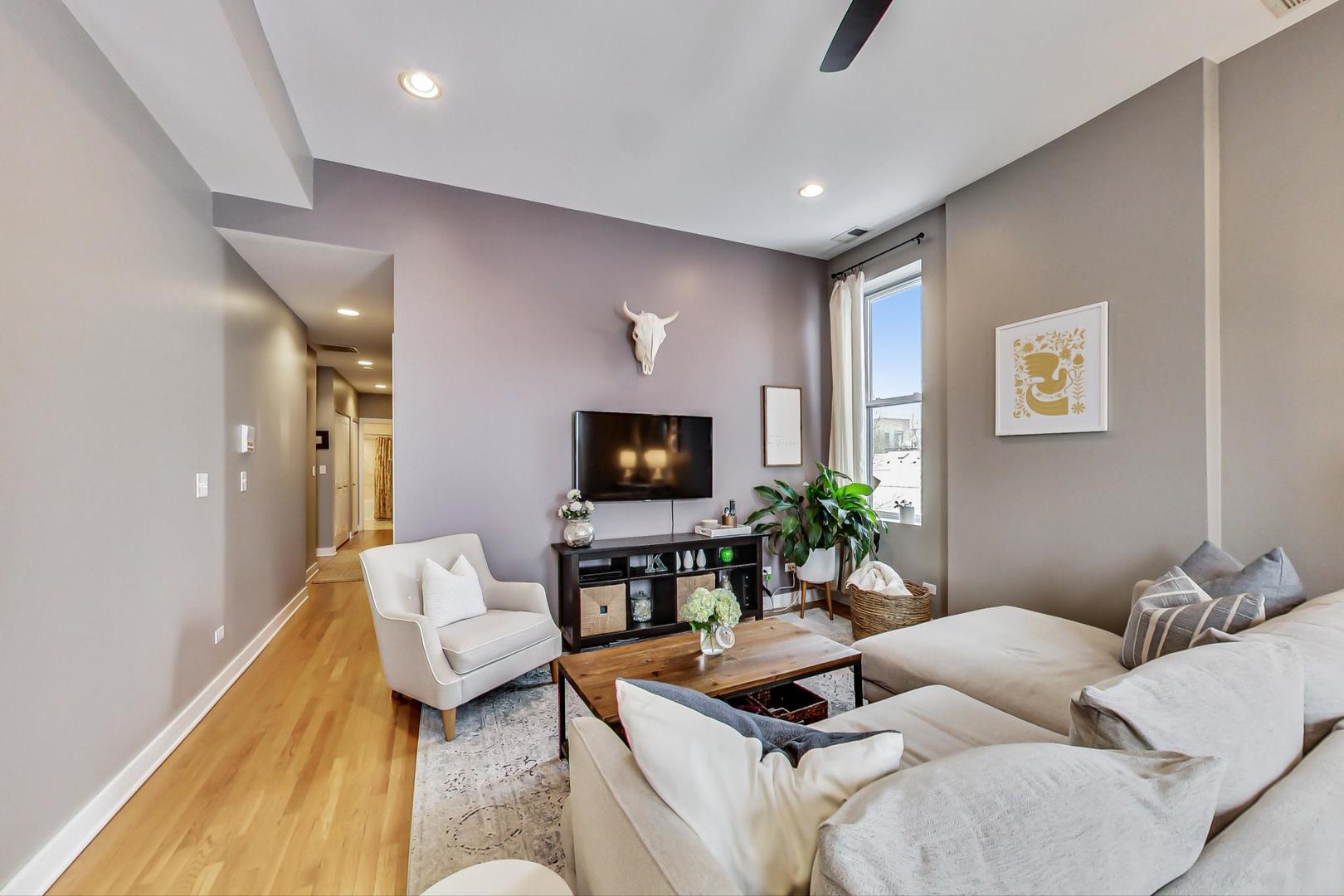1256 North Cleaver Street, Unit 2E Chicago, IL 60642 - Photo 6 of 18 a living room with furniture and a flat screen tv
