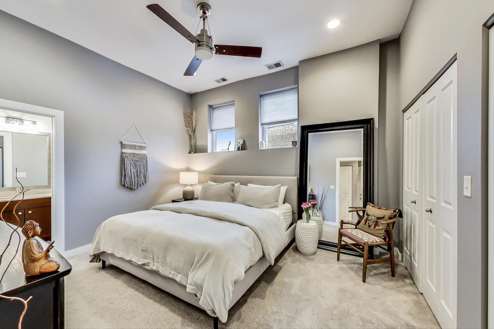 1256 North Cleaver Street, Unit 2E Chicago, IL 60642 - Photo 10 of 18 a bedroom with a bed and a mirror