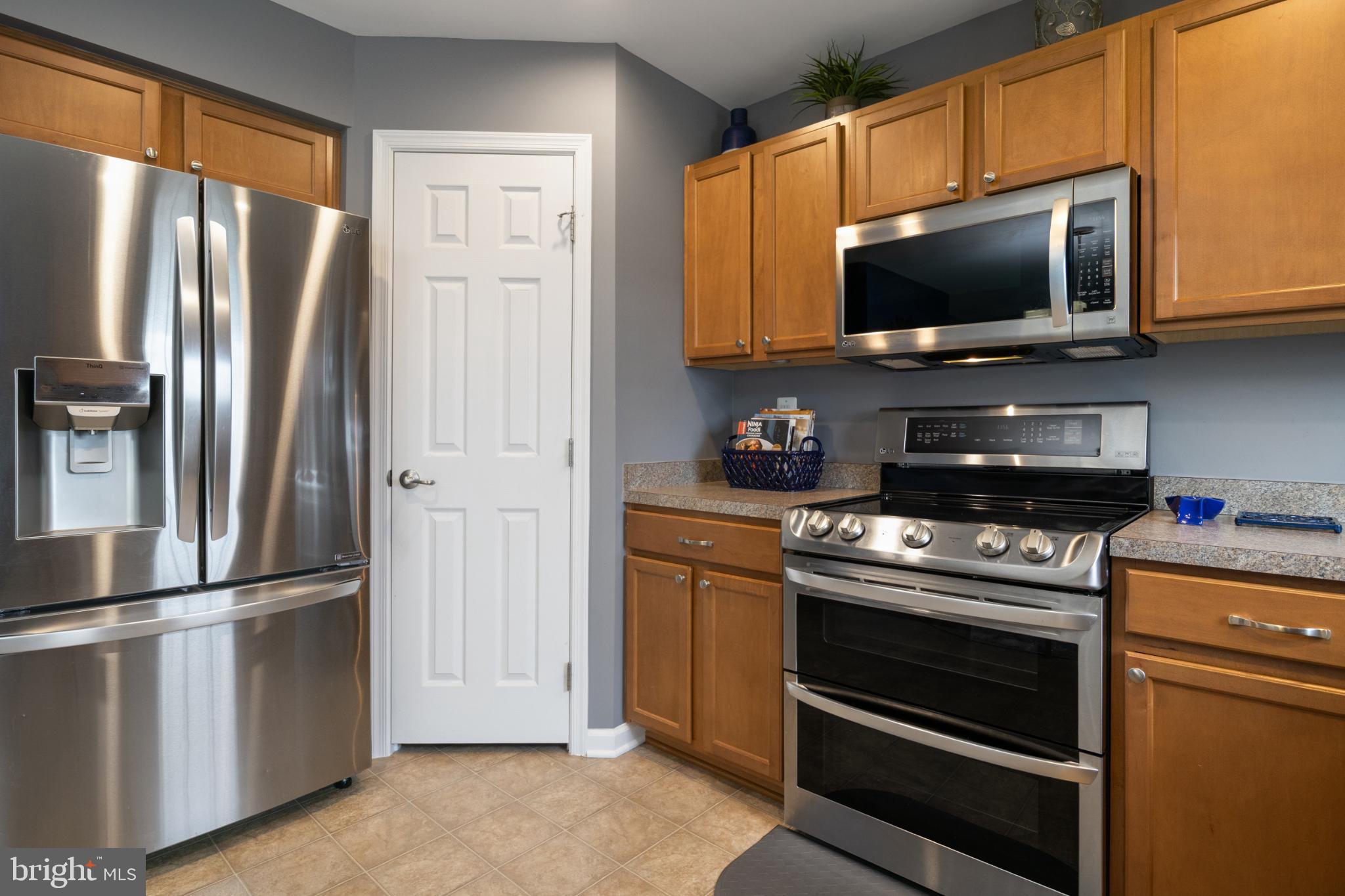 856 Countryside Road Seven Valleys, PA 17360 - Photo 11 of 47 a kitchen with stainless steel appliances a refrigerator stove and microwave