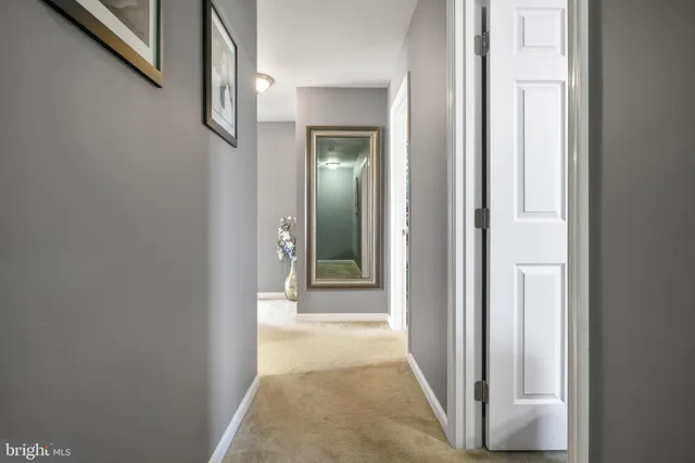 a view of a hallway with a wooden door