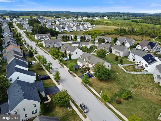 an aerial view of residential houses with outdoor space and river