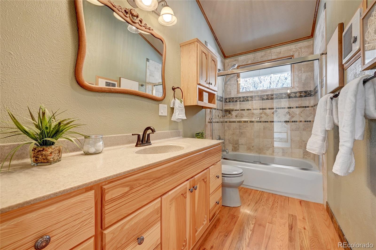 32856 Timber Ridge Road Evergreen, CO 80439 - Photo 15 of 41 a bathroom with a granite countertop sink a toilet and shower