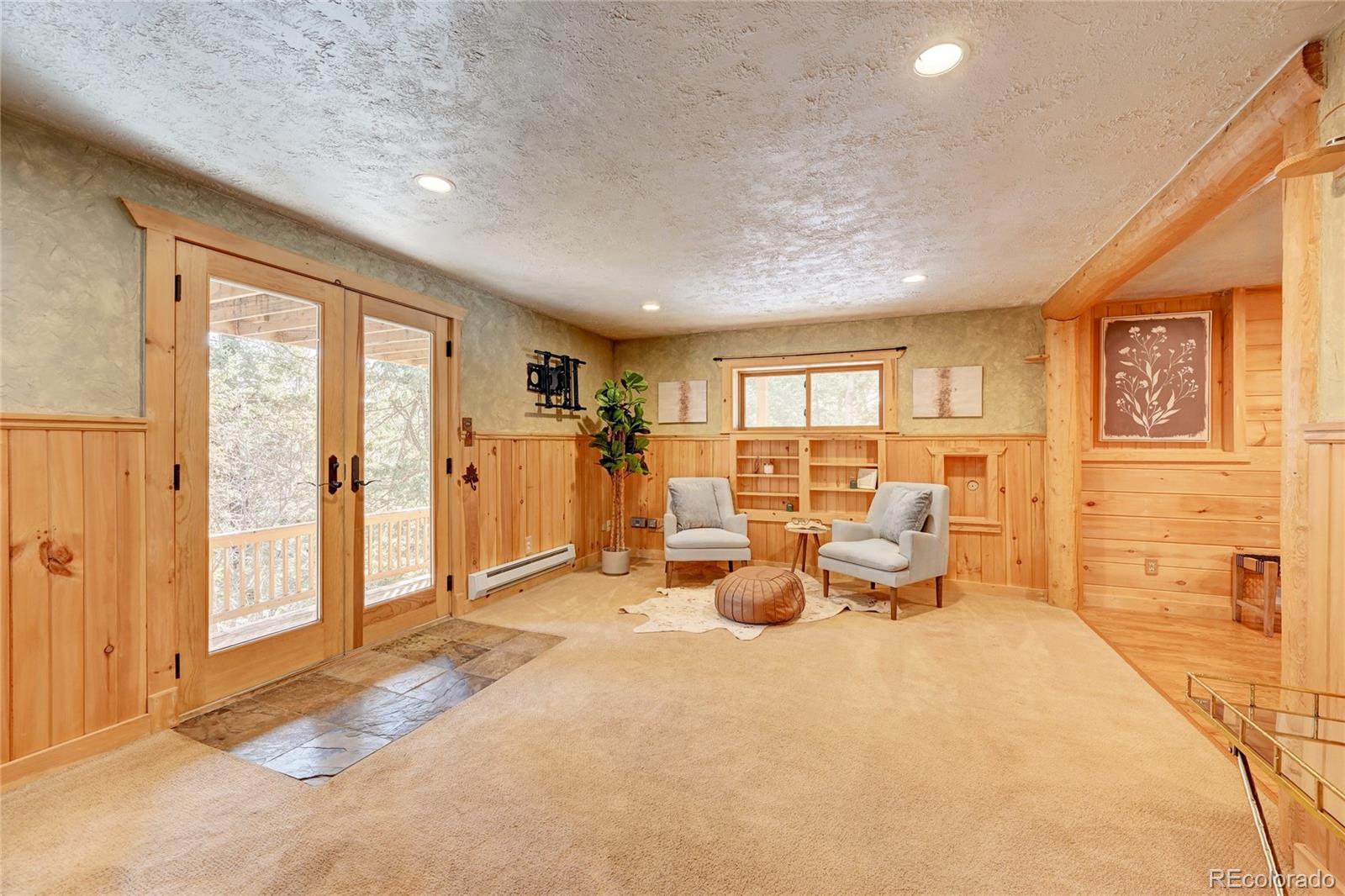 32856 Timber Ridge Road Evergreen, CO 80439 - Photo 16 of 41 a living room with furniture large window and flat screen tv