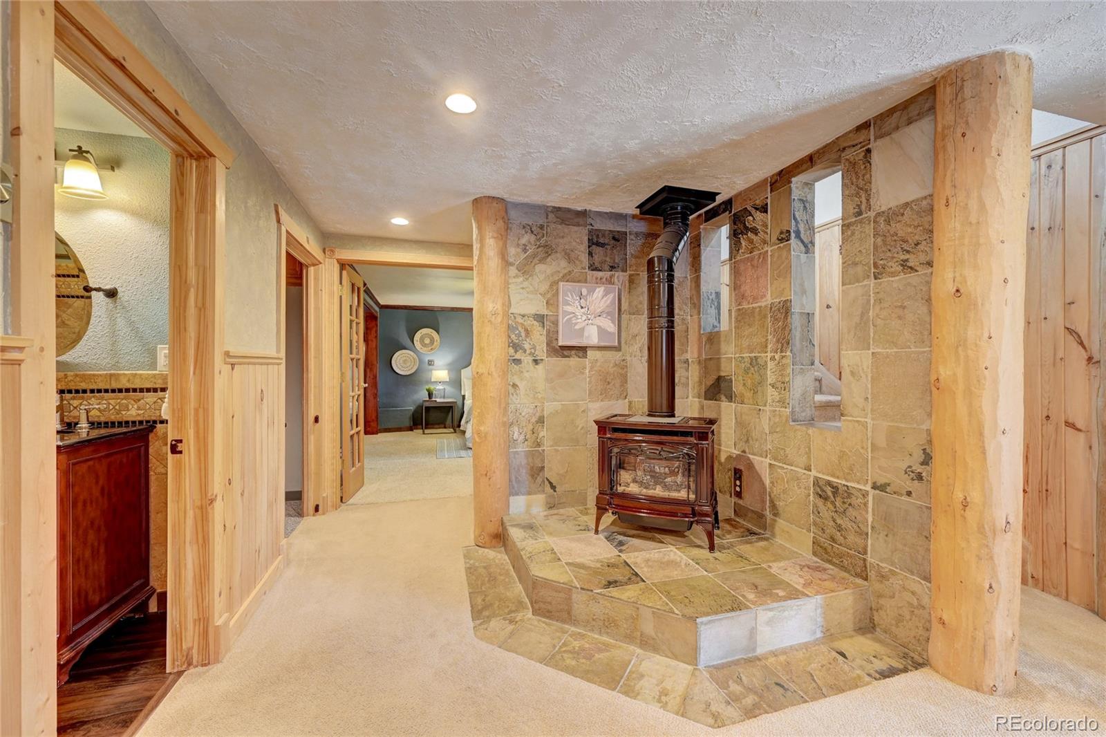 32856 Timber Ridge Road Evergreen, CO 80439 - Photo 18 of 41 a bathroom with a tub shower and a sink