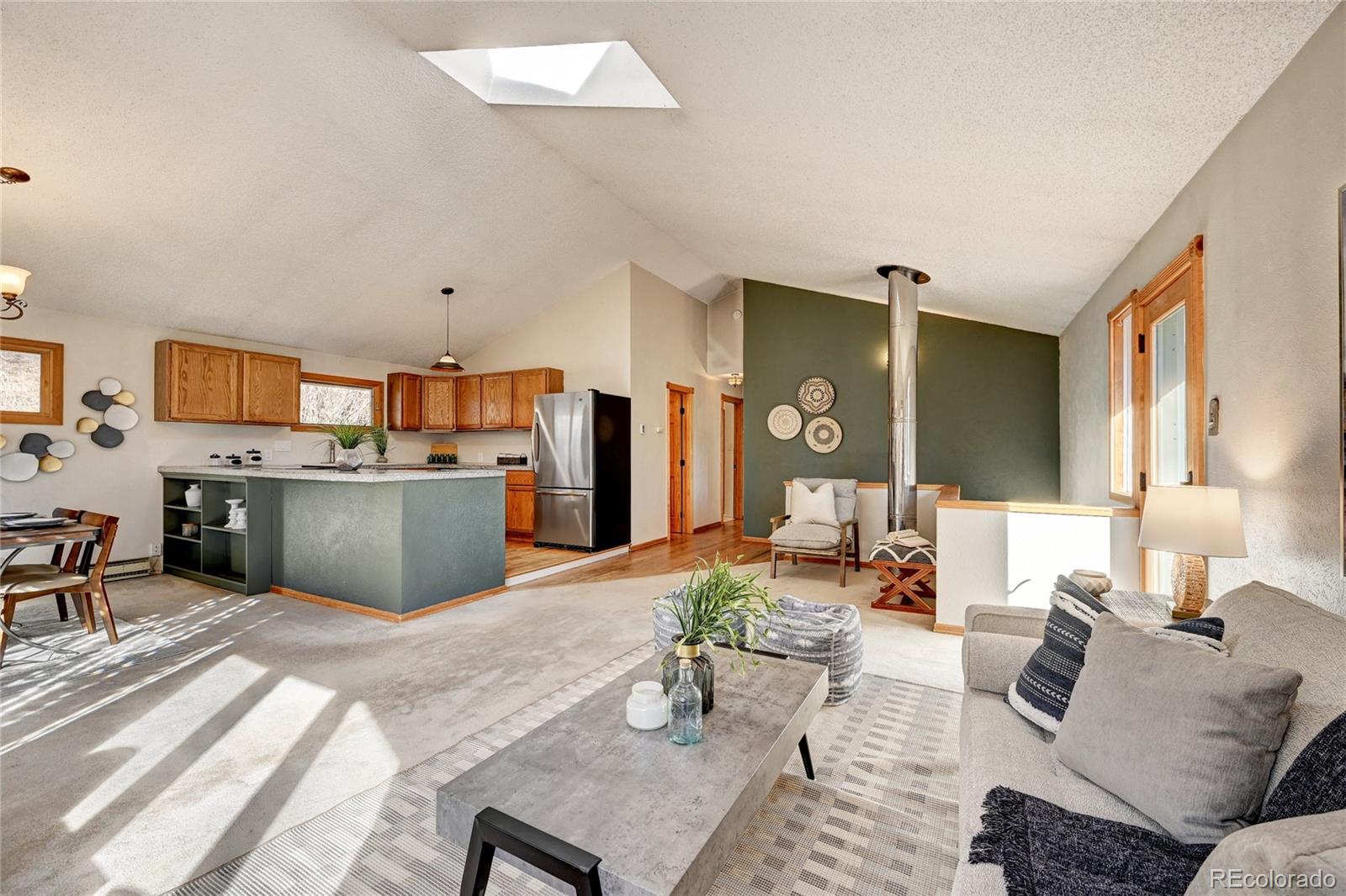 32856 Timber Ridge Road Evergreen, CO 80439 - Photo 2 of 41 a living room with furniture kitchen view and a window