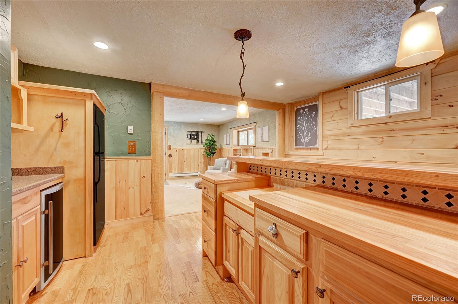 32856 Timber Ridge Road Evergreen, CO 80439 - Photo 21 of 41 a kitchen with stainless steel appliances granite countertop a refrigerator a stove and a wooden floors