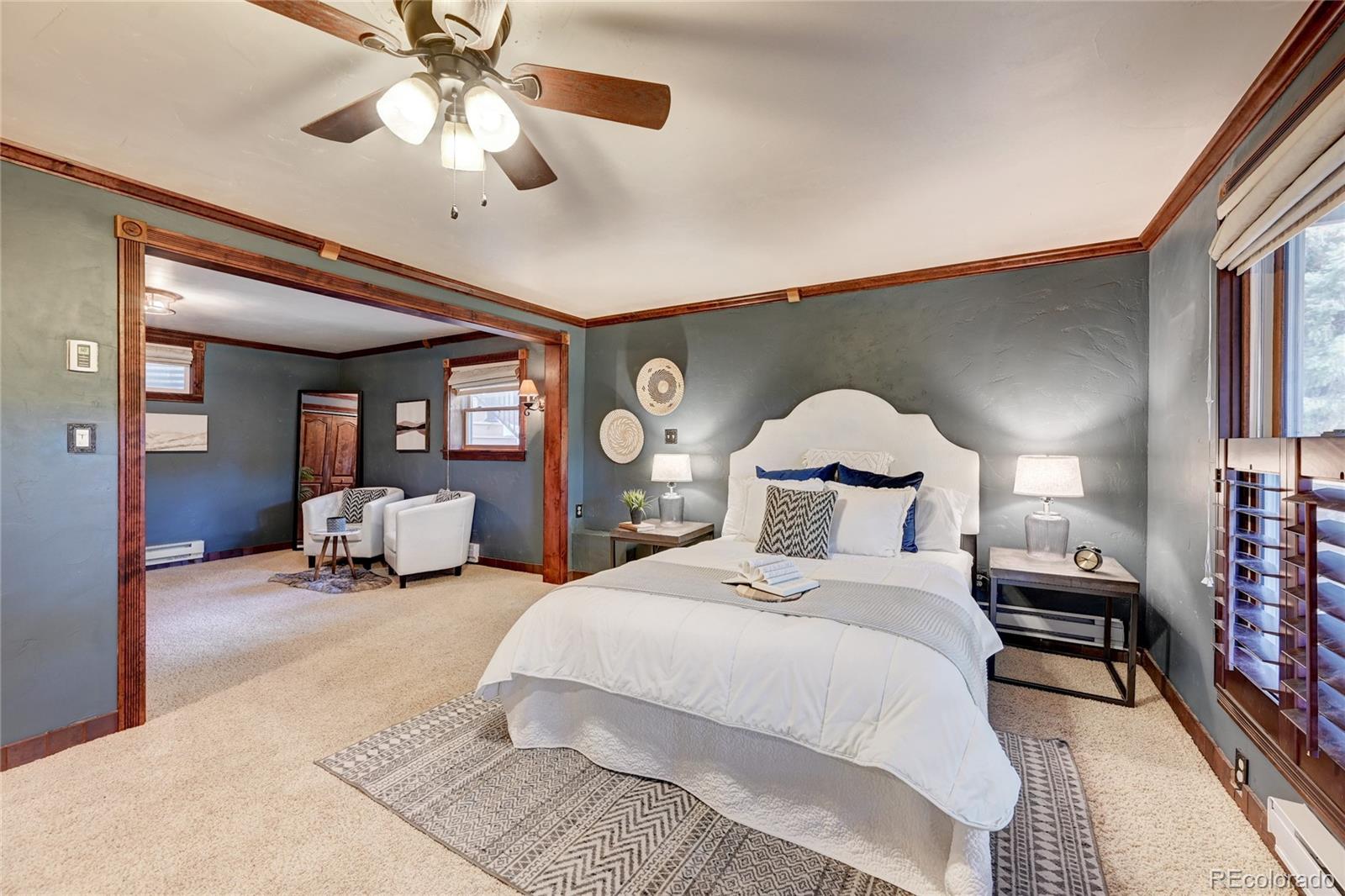 32856 Timber Ridge Road Evergreen, CO 80439 - Photo 23 of 41 a spacious bedroom with a bed and ceiling fan