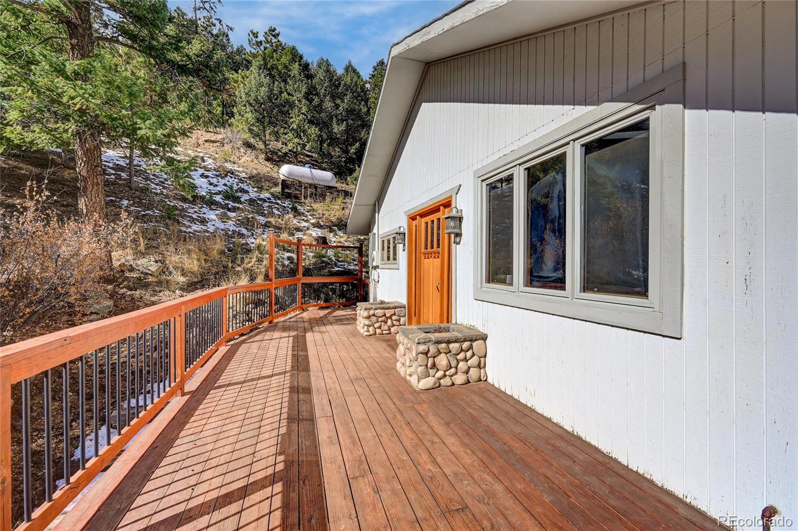 32856 Timber Ridge Road Evergreen, CO 80439 - Photo 30 of 41 a view of a balcony with wooden floor and iron fence